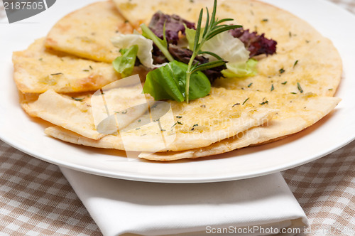 Image of garlic pita bread pizza with salad on top