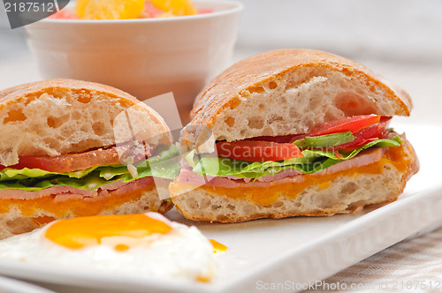 Image of ciabatta panini sandwich eggs tomato lettuce