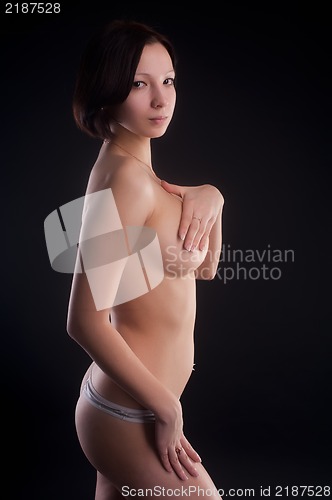 Image of topless woman body covering her breasts