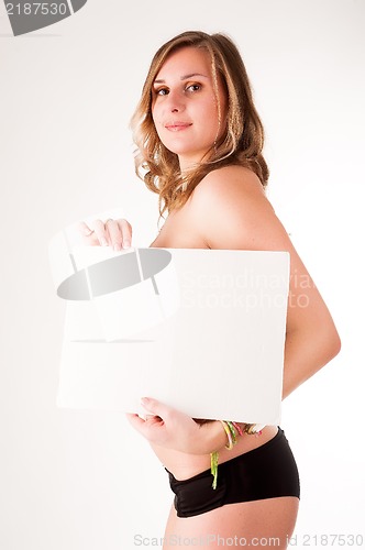 Image of sexy nude woman holding blank banner