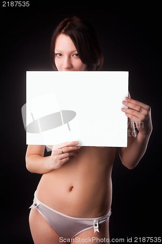 Image of sexy nude woman holding blank banner