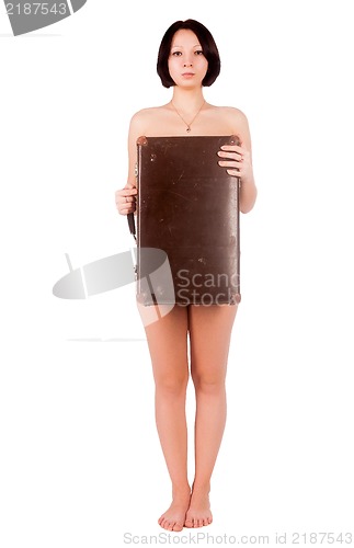 Image of sexy nude woman covering her body by suitcase