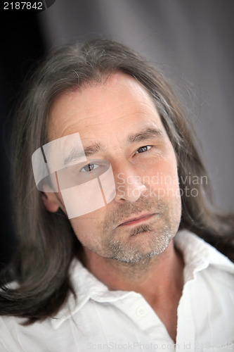 Image of Serious unshaven man with long hair