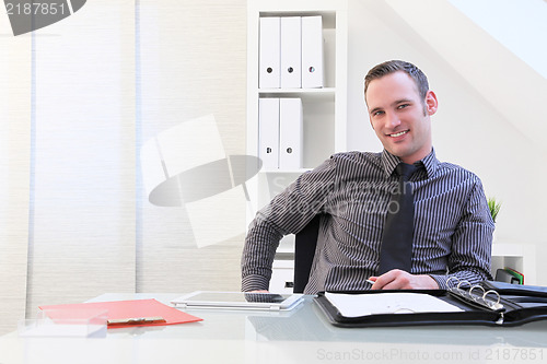 Image of Smiling successful young businessman