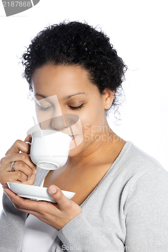 Image of Dark skinned lady enjoys her coffee