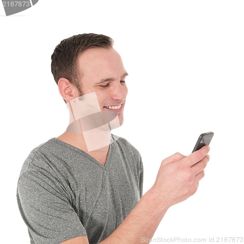 Image of Happy young man reading a text message