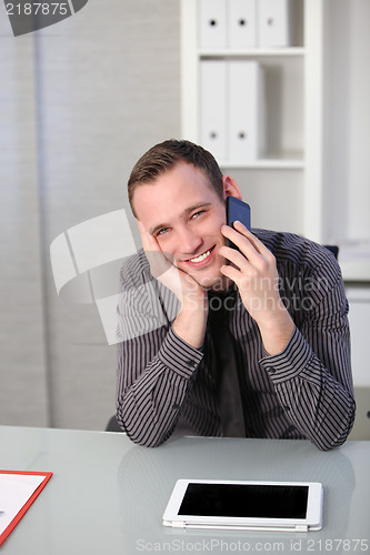 Image of Business man using a mobile at his desk