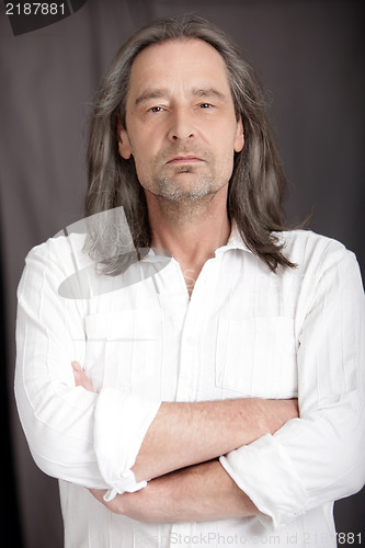 Image of Serious man with shoulder length hair