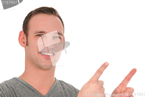 Image of Smiling young man pointing upwards