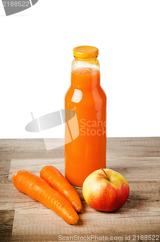 Image of Bottle with carrots juice and an apple