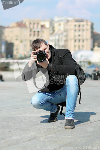 Image of Young man with camera