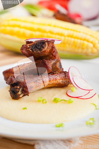 Image of pork ribbs on polenta corn cream bed