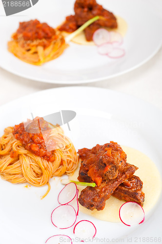 Image of pasta with pork ribbs sauce on polenta bed