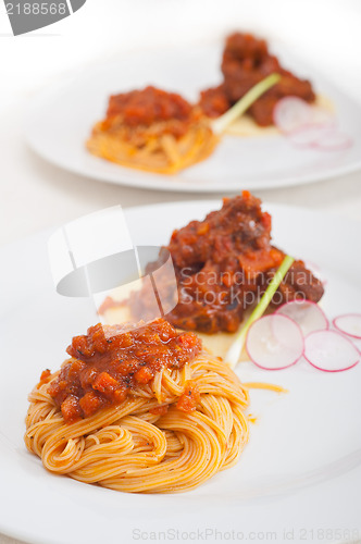 Image of pasta with pork ribbs sauce on polenta bed
