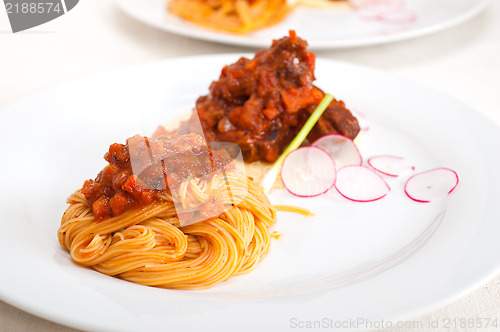 Image of pasta with pork ribbs sauce on polenta bed