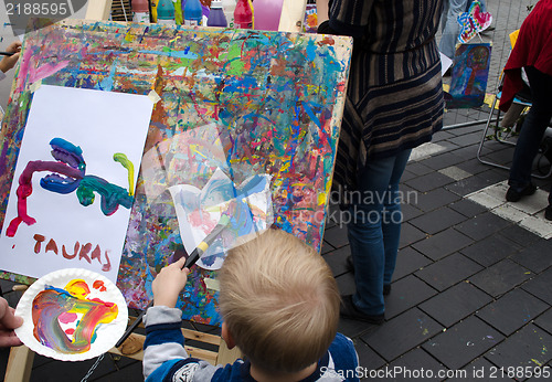 Image of kid draw paintings brush outdoor street event 