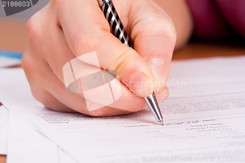 Image of Woman writing in organizer