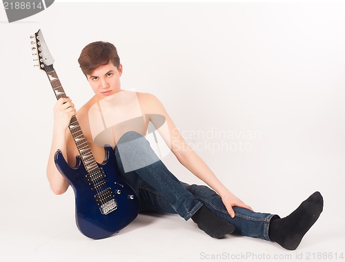 Image of young fit male with electric guitar