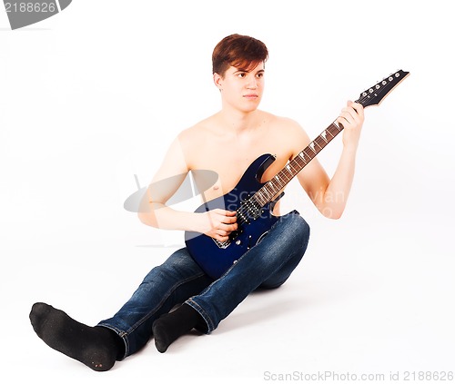 Image of young fit male with electric guitar
