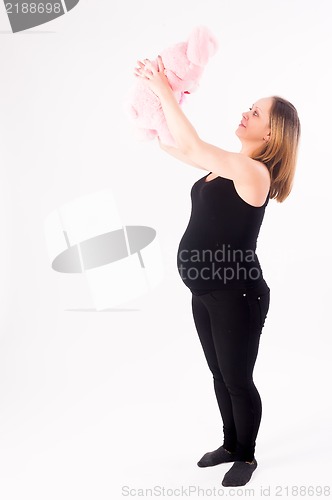 Image of beautiful pregnant woman with toy