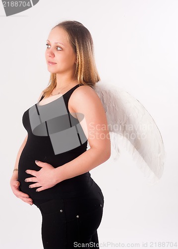 Image of beautiful pregnant woman with angel wings