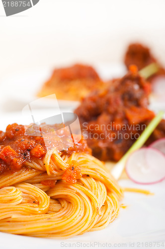 Image of pasta with pork ribbs sauce on polenta bed