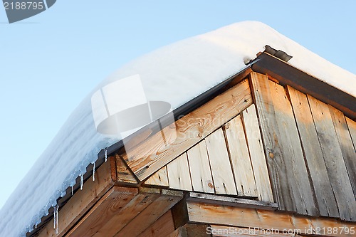 Image of Roof of rustic wooden with snow