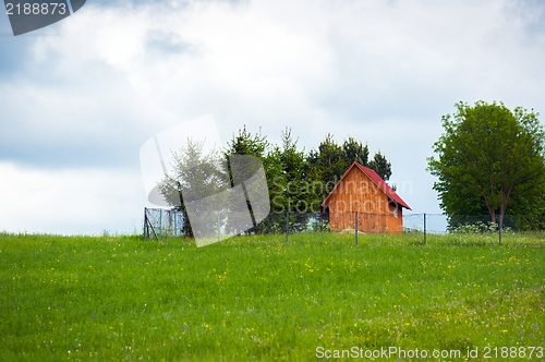 Image of Small wooden house on the top of a hill
