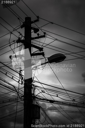 Image of Photo of an electric pole with a many cables