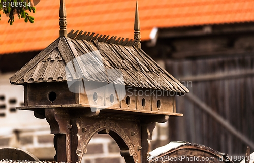 Image of Decorated bird feeder made out of wood