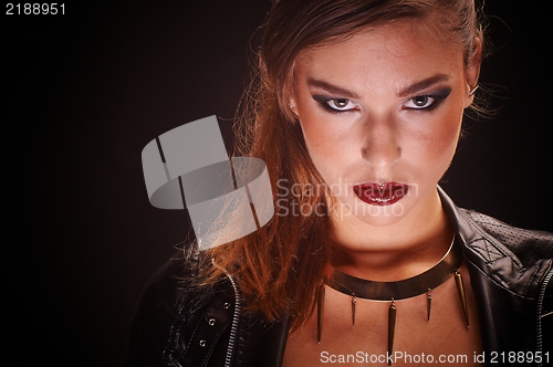Image of Young woman against dark background