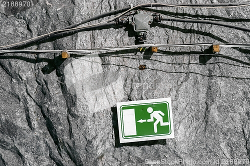 Image of Green exit sign on cave wall