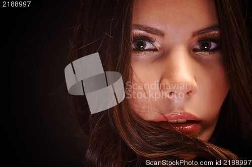 Image of Young woman against dark background