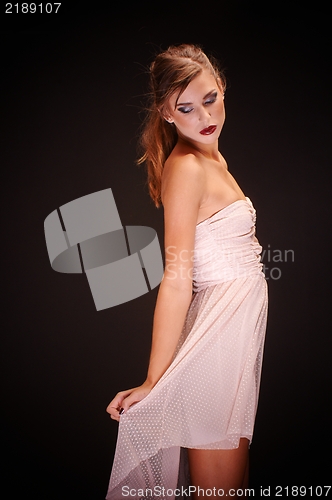 Image of Young woman against dark background