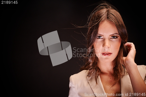 Image of Young woman against dark background