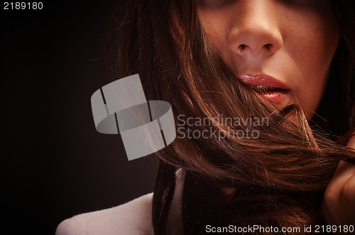 Image of Young woman against dark background