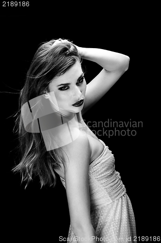 Image of Young woman against dark background