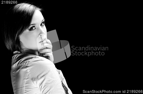 Image of Young woman against dark background