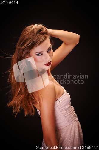 Image of Young woman against dark background