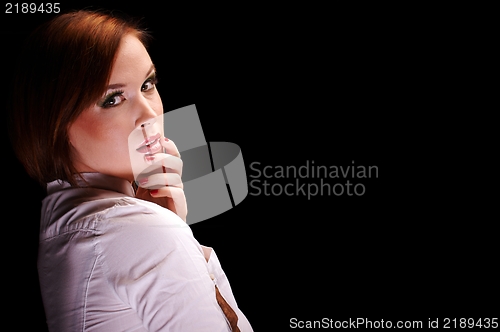 Image of Young woman against dark background