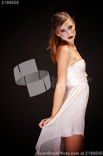 Image of Young woman against dark background