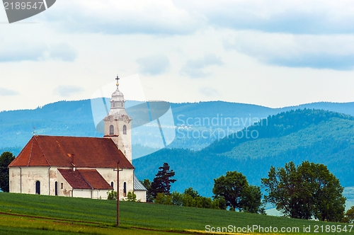 Image of Small church with blue mountains