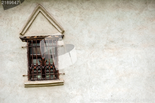 Image of Rusty old window on white wall