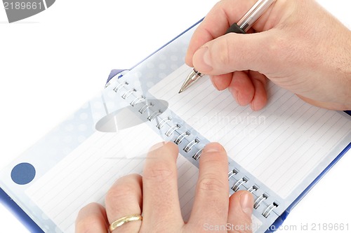 Image of Close-up of hand beginning to write on notes