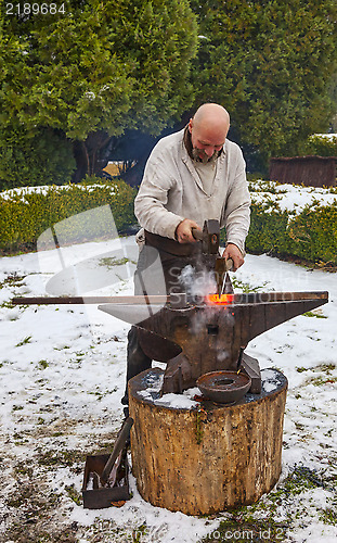 Image of Blacksmith Working Outside in Winter