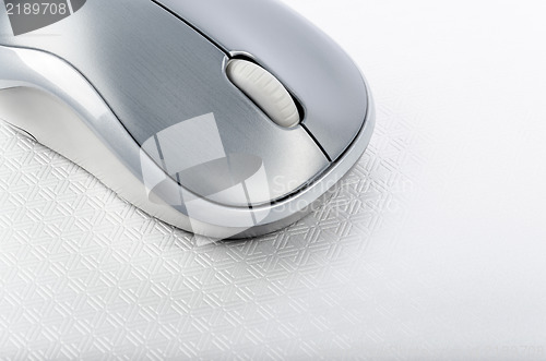 Image of Wireless computer mouse on a metallic background