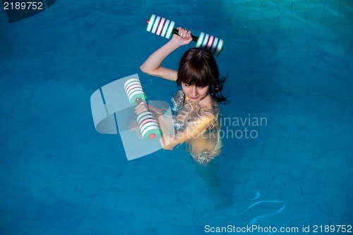 Image of Attractive girl trains in aqua aerobics