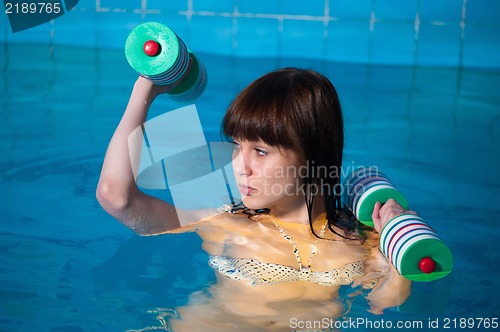 Image of Pretty girl doing aqua aerobic exercise