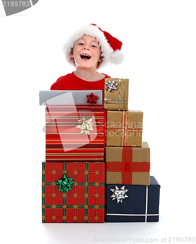 Image of Young boy laughing behind gifts