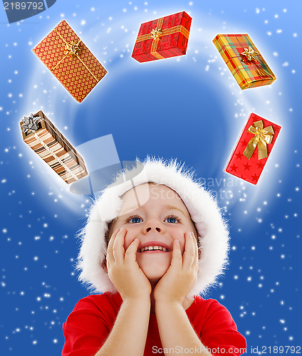 Image of Boy looking to copy space surrounded by gifts